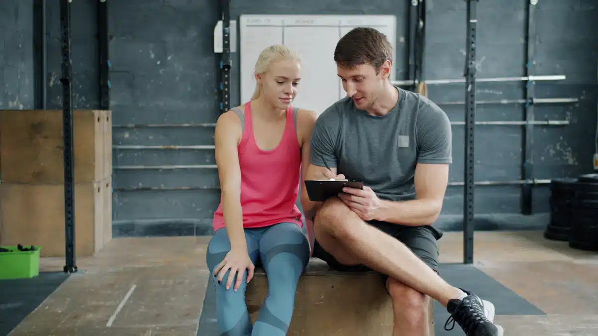 Entrenador y atleta consultan datos de entrenamiento en una tableta